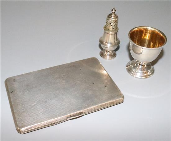 Silver cigarette case, small Victorian pepperette and an egg cup